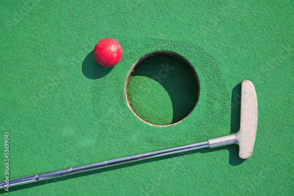 Fototapeta Close-up of miniature golf hole with bat and ball