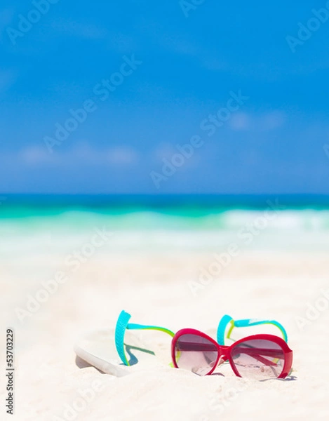 Fototapeta sun glasses and flip flops on a tropical Mexican beach