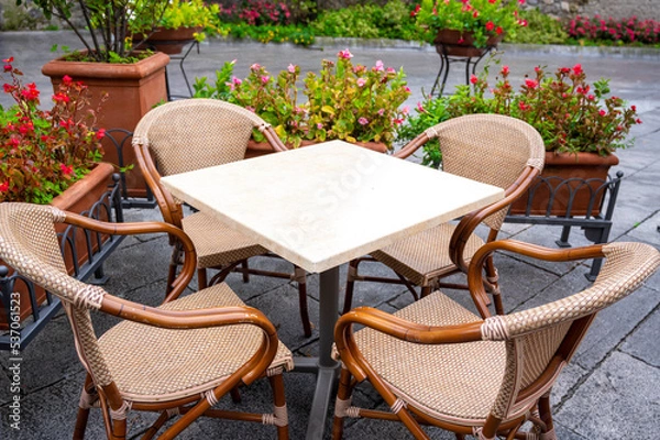 Obraz table with wicker chairs of a street cafe