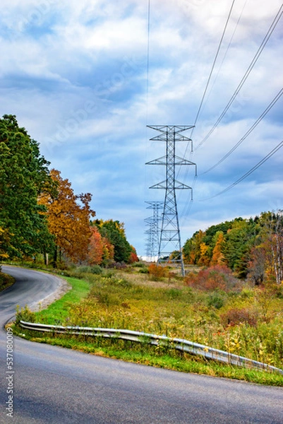 Obraz Large power lines in the field, along a  rural road, in Autumn in Upstate NY. The beautiful fall colors surround the power transmission lines here in NY.