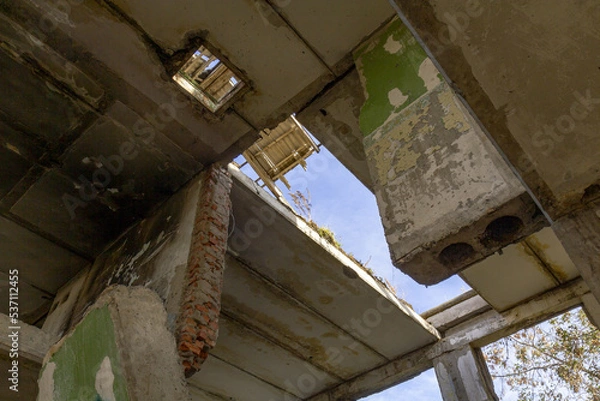 Obraz The roof destroyed after the bombing in an industrial building.