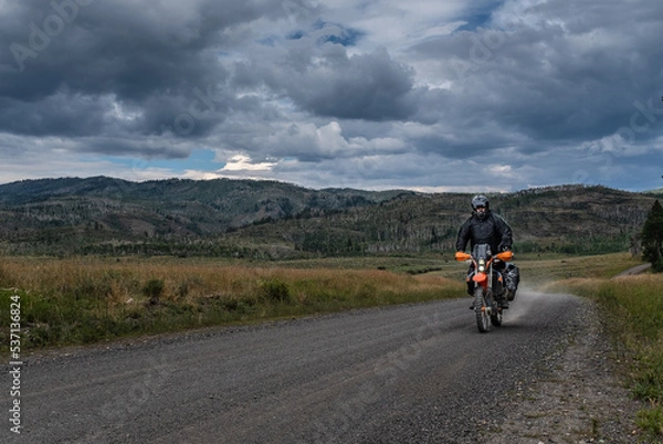 Obraz Off road motorcyclist riding on the continental Divide Ride in Colorado at dusk.  