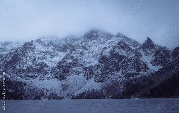 Obraz Snowy mountain peaks at Morskie Oko, Poland on a foggy, cold winter afternoon.