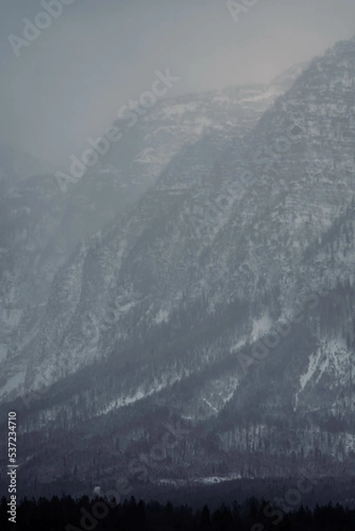Obraz Mountain range with strong atmosphere during a snowy, dark winter afternoon