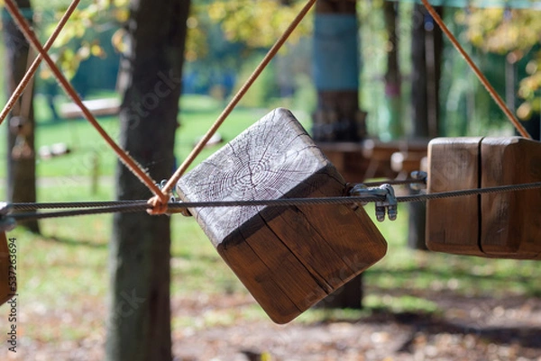 Obraz The bridges, ropes and ladders of the Adventure Park are designed for beginners among the tall trees. Adventure climbing in a high ropes course