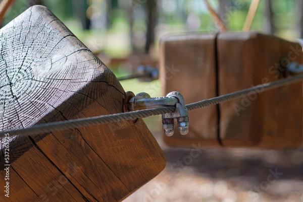 Obraz The bridges, ropes and ladders of the Adventure Park are designed for beginners among the tall trees. Adventure climbing in a high ropes course
