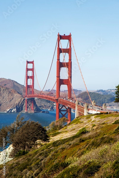 Fototapeta Famous Golden Gate bridge in San Francisco with a clear blue sky and wavy sea