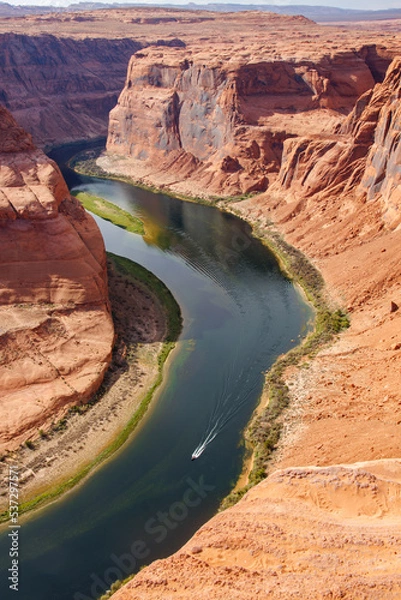 Fototapeta View of Horseshoe Bend of Colorado river with a motor boat in the river
