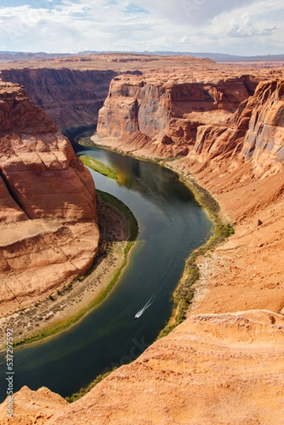 Fototapeta View of Horseshoe Bend of Colorado river with a motor boat in the river