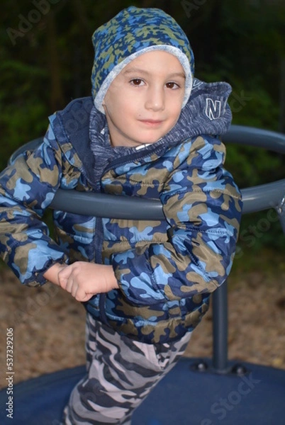 Fototapeta portrait of a child on a merry go round 