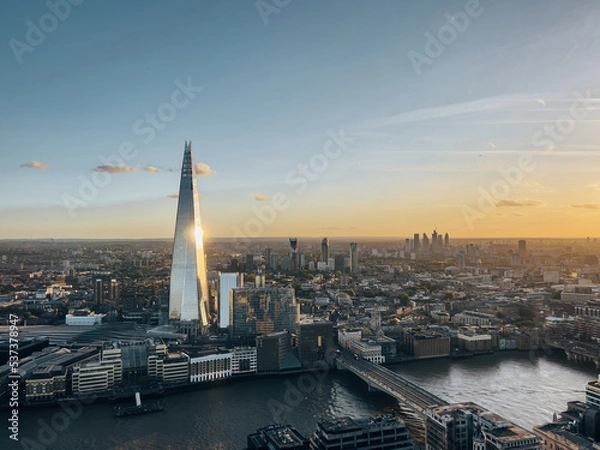 Fototapeta Aerial view on the Shard tower in central London with river Thames and bridge during sunset