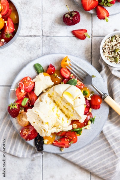 Obraz Salad with burrata cheese, cherry tomatoes and strawberry with microgreen and olive oil. Traditional Italian burrata cheese. Healthy eating concept. Keto diet.