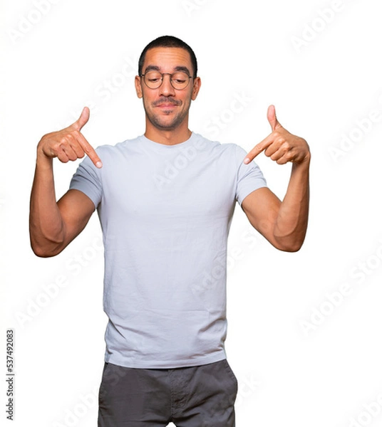 Obraz Surprised young man pointing down