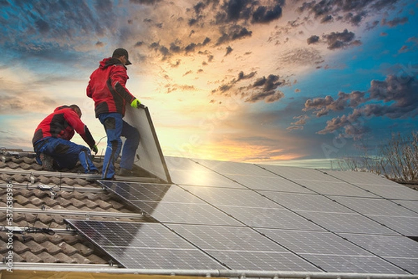 Fototapeta Installing solar photovoltaic panel system. Solar panel technician installing solar panels on roof. Alternative energy ecological concept.
