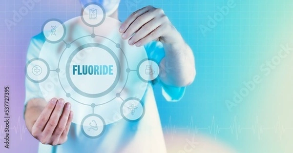 Fototapeta Fluoride. Medicine in the future. Doctor holds virtual interface with text and icons in circle.