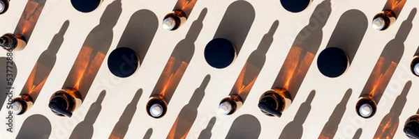 Obraz Banner made with brown glass bottle of cosmetic products and strong shadow on beige background, as a backdrop or texture. Creative layout for your design