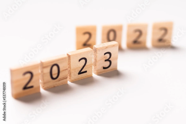 Fototapeta 2022 to 2023 text on wooden blocks with copy space for concept background. Resolution, plan, review, goal, start, end year and New Year holiday concepts