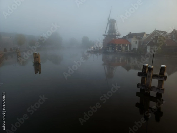 Obraz Windmill de Adriaan on a misty morning on the Spaarne River in Haarlem in the Netherlands