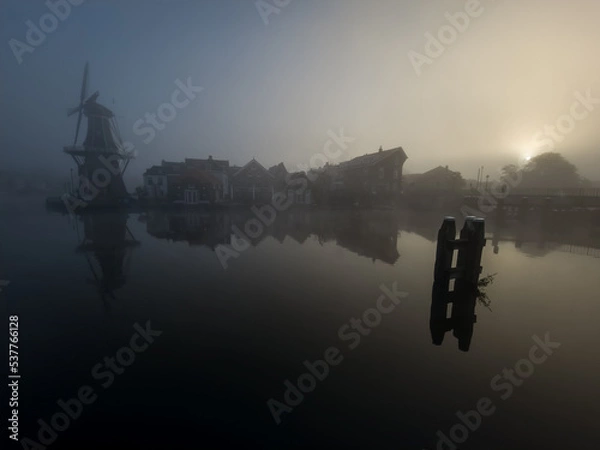 Obraz Windmill de Adriaan on a misty morning on the Spaarne River in Haarlem in the Netherlands