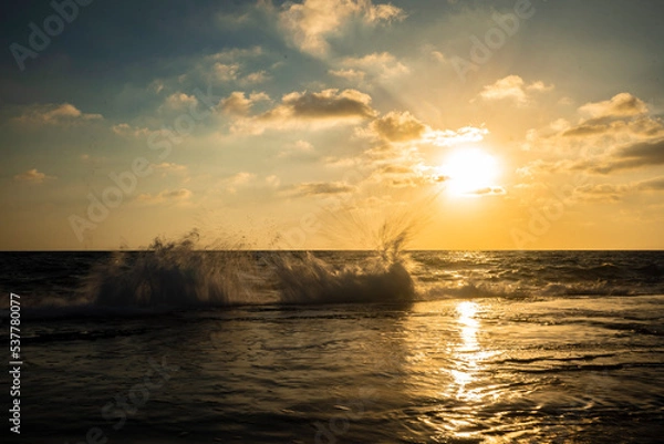 Fototapeta Beautiful view of the sea with the sun shining in a blue sky in the background