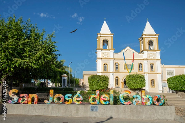 Obraz Exterior of Mission San Jose del Cabo with bird flying in sky above