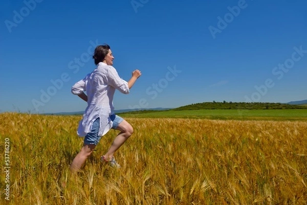 Fototapeta young woman in wheat field at summer
