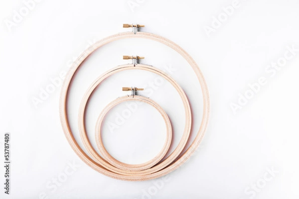 Fototapeta Three needlework embroidery hoops on white background