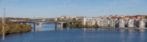 Fototapeta Panorama over the Essingen islands and the motorway bridges of Essingeleden and Traneberg, a bay in the lake Mälaren a sunny a color full autumn day in Stockholm