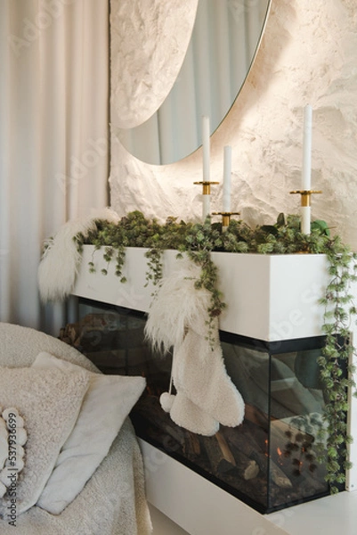 Fototapeta New Year's decorations. New Year's decorations. Fireplace with candlesticks. Luxury living room with a Christmas decor. Holiday background.