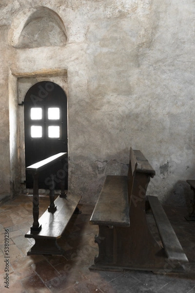 Fototapeta Old door and bench in an old church