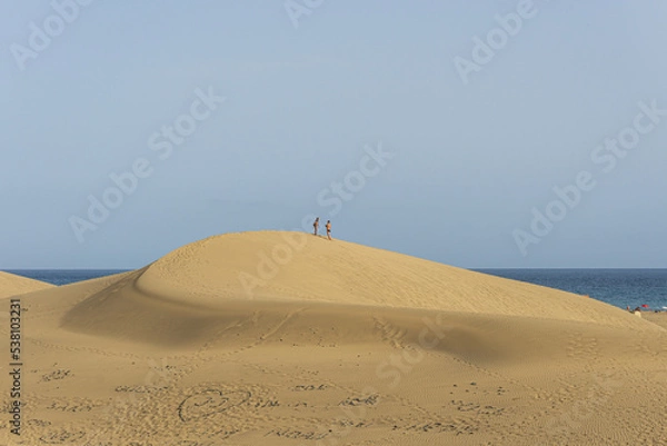 Fototapeta People walking on Maspalomas dunes during summer season in Maspalomas, Gran Canaria, Spain