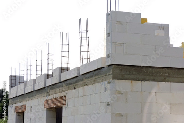Fototapeta A reinforced concrete beam, steel reinforcement for pillars on the first floor of a house under construction, a reinforced brick lintel, a rough window opening , walls made of aac