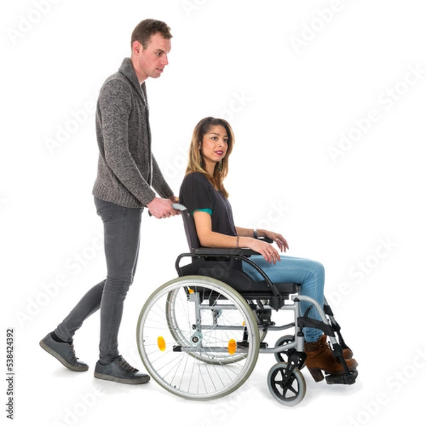 Fototapeta Man pushing woman in a wheelchair isolated on transparent background