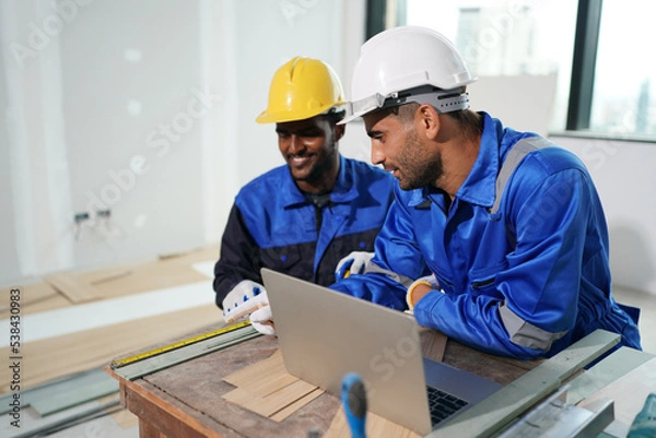 Fototapeta Architect and construction engineer or surveyor discussion plans and blueprints