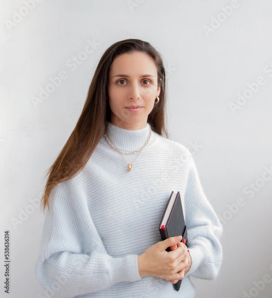 Fototapeta Low angle of young pretty bussines woman standing with arms crossed isolated on white background