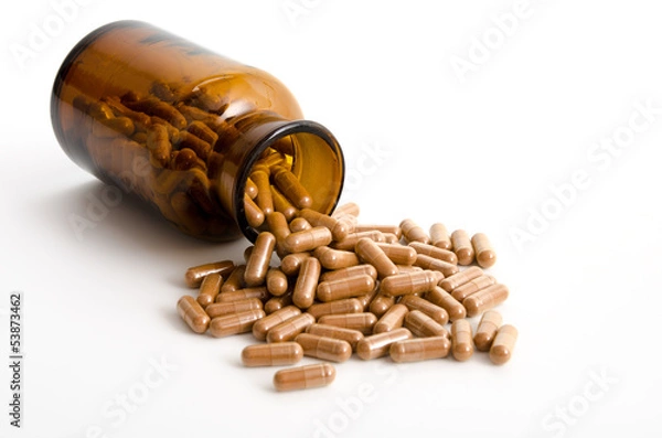 Fototapeta Kapseln mit braunem Pulver