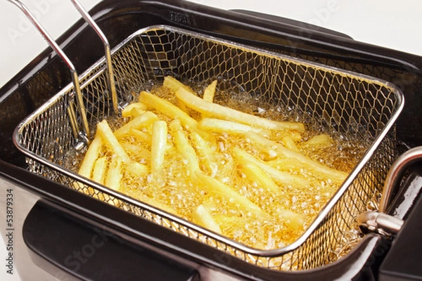 Obraz French fries in hot fat in a deep fryer