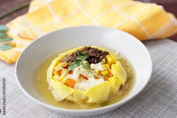 Fototapeta Sop Matahari is a dish from Surakarta, Central Java. This soup made from mushroom, chicken chop, carrot, corn,celery and then wrapped by fried egg added chicken stock and fried onion.