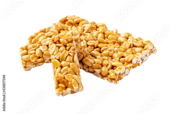 Fototapeta Brittle peanut chikki isolated on white background. Caramelized groundnut bars. Nut candy.