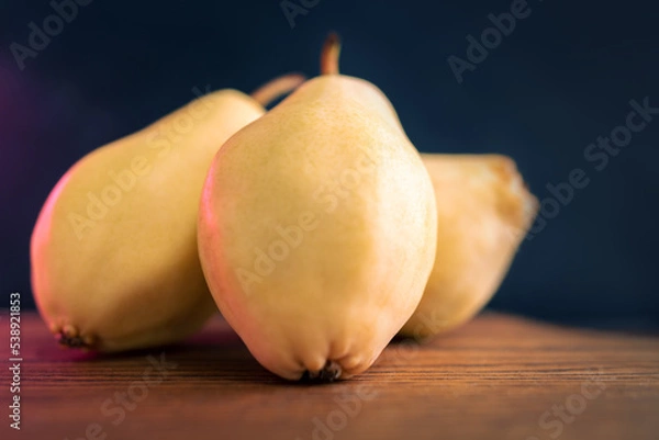 Obraz Three Whole Pears Paced On A Slate Board. Healthy Food. Eco-Friendly Products. Selective Focus. Side View. Dark Background.
