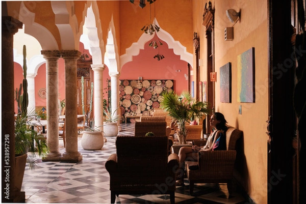 Obraz Girl waiting in a chair in a hall of an hacienda 