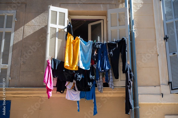 Obraz drying clothes on an old window