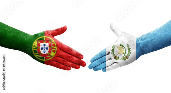Fototapeta Handshake between Guatemala and Portugal flags painted on hands, isolated transparent image.