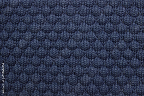 Fototapeta Blue background of knitted fabric, sweater close-up, concept of warm autumn and winter clothing, care washing and dry cleaning, with an empty space for the fabric, copy space, decoration, упаковка