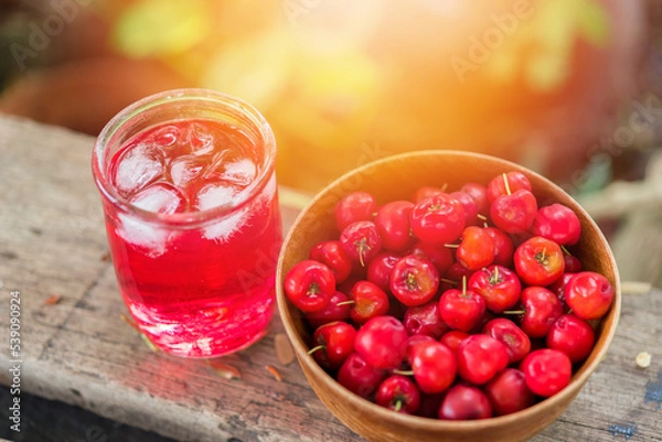 Fototapeta Glass of sour cherry juice with fresh red cherries, Cherry juice, on wood background, red drink, High vitamin C and antioxidant fruits.