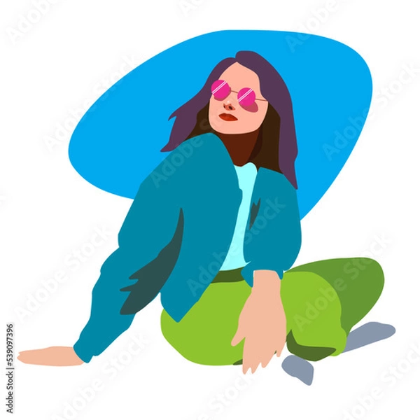 Fototapeta The girl is sitting in a jacket and jeans on the lawn with pink glasses.