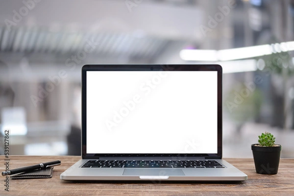 Obraz Desk Laptop with blank screen on table  blur background with bokeh background that is used for editing