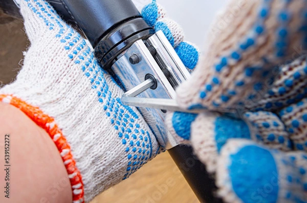 Fototapeta Using hex wrenches, or allen keys to repair your bike yourself at home.