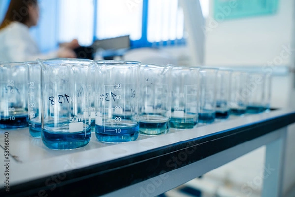 Obraz Laboratory for analysis of flasks with blue liquid a lot