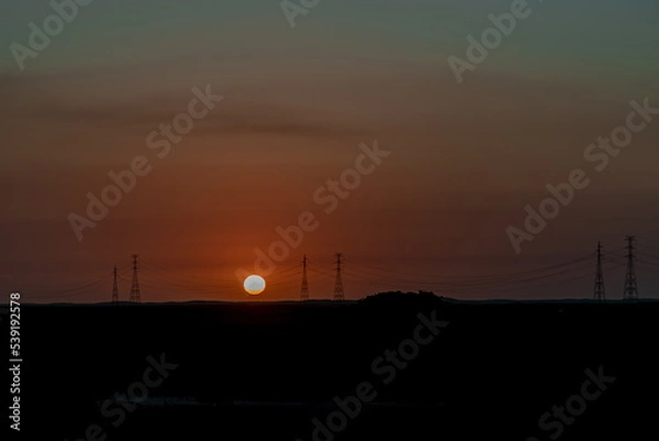 Obraz Por do sol e torres de energia